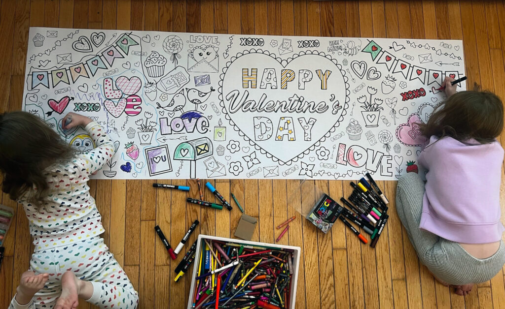 Kids coloring a Valentine's Day themed MyLittlePicassos giant coloring banner together